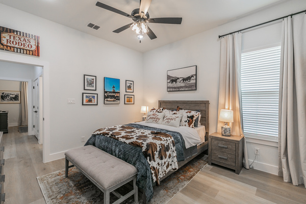 The Rodeo Room with queen bed, smart TV, ceiling fan and clothing storage