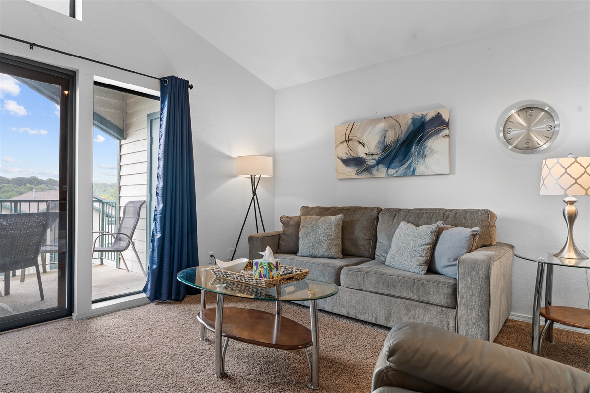 Comfortable seating, soft tones, and balcony access make this a natural place to relax at the end of the day.