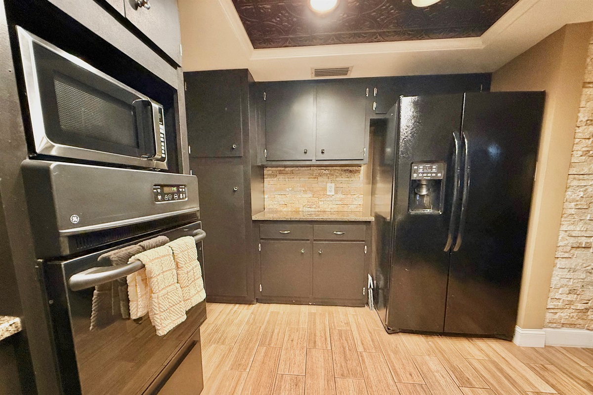 You'll love the layout that offers generous counter space, plenty of storage, and a full suite of stainless and black appliances to meet all your culinary needs.