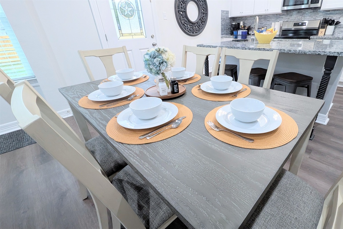 There is room and place settings for every guest at the dining table and kitchen island.