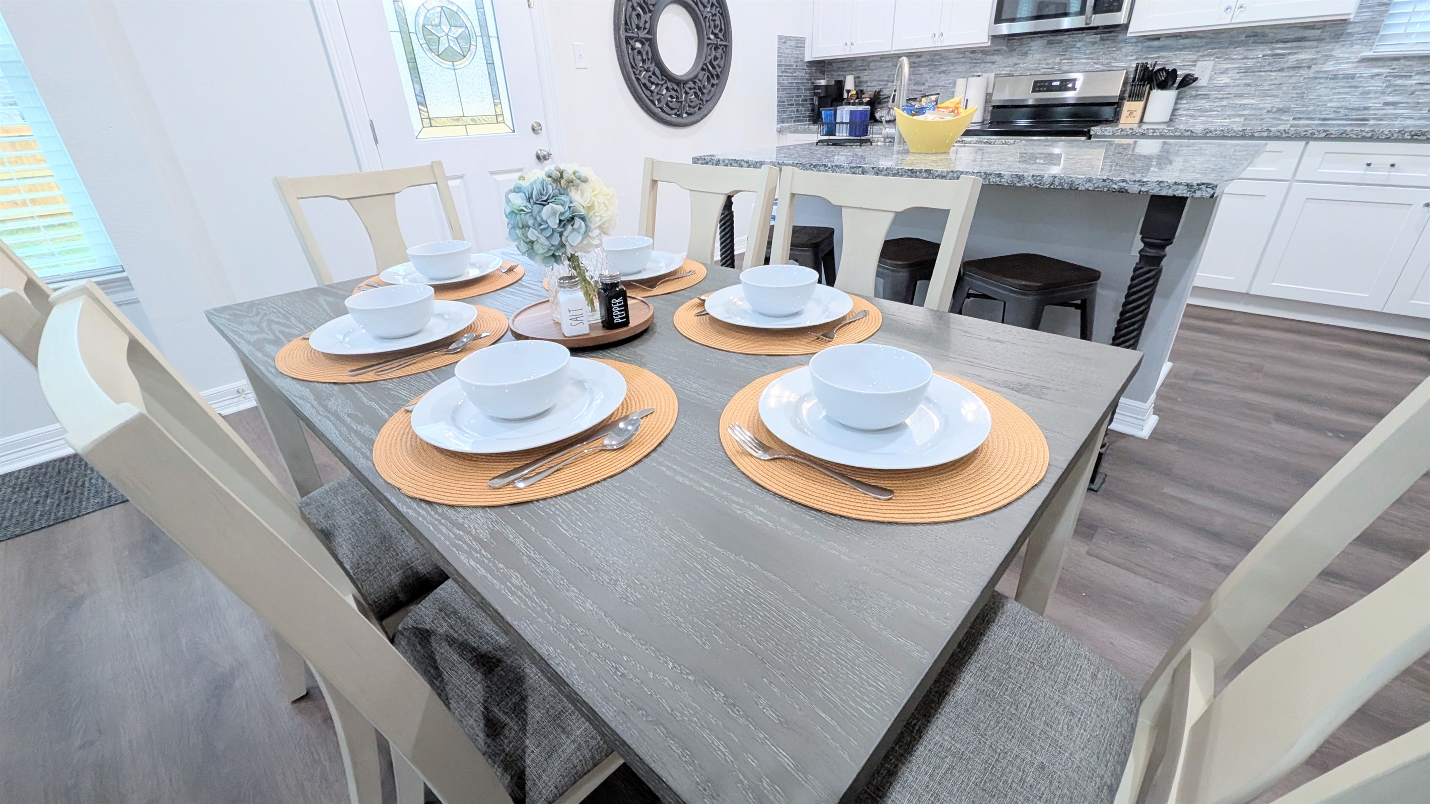 There is room and place settings for every guest at the dining table and kitchen island.