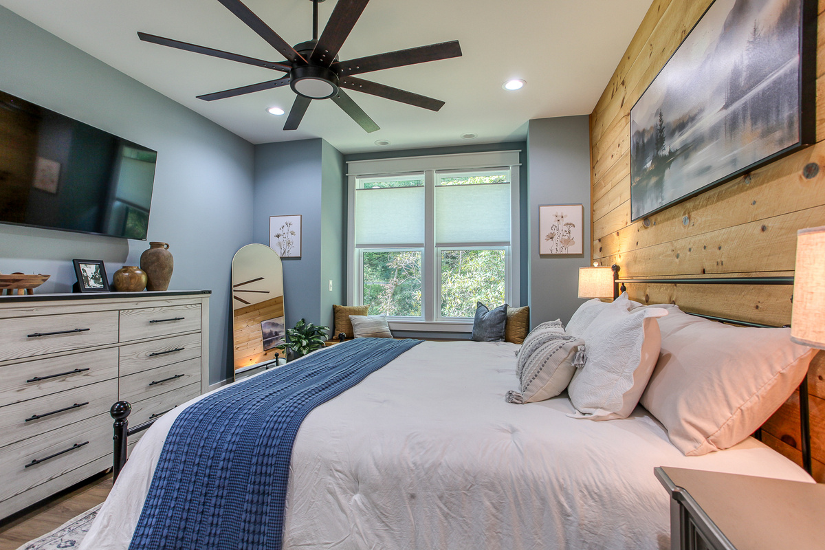 The primary bedroom at Robbin’s Nest on Snowbird Creek offers a king bed, smart TV, and dresser space to help you settle in.