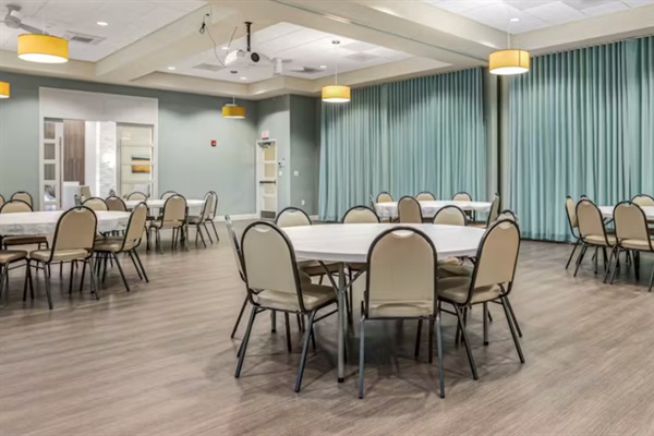 Versatile Event Hall: Host birthday parties, workshops, or group dinners in a spacious, flexible room with round tables and seating to suit any occasion.