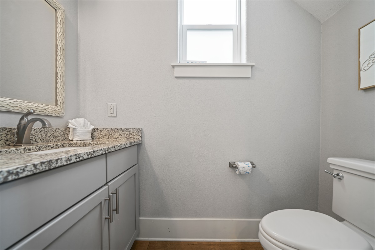 Downstairs half bath with granite vanity and updated fixtures.
