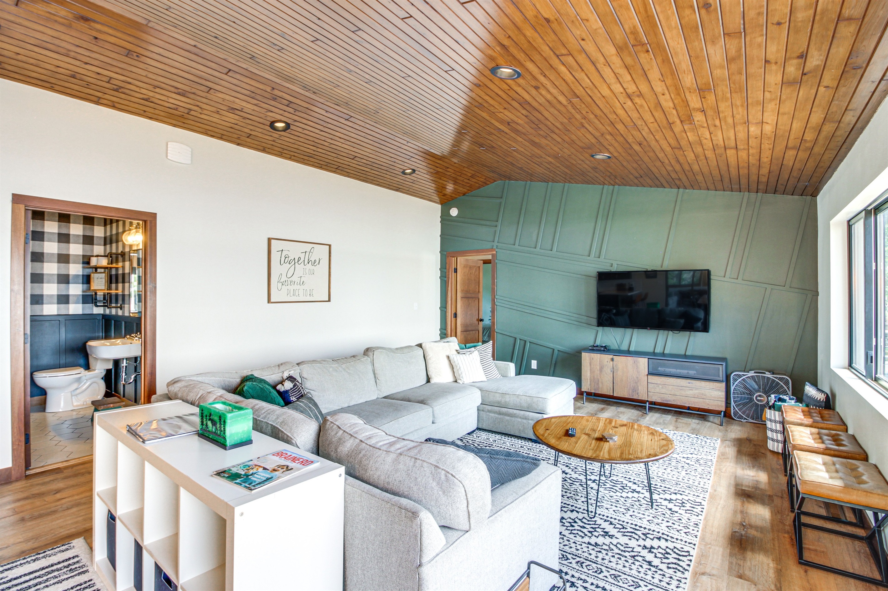 Open living room with vaulted wood ceiling and lake-facing windows