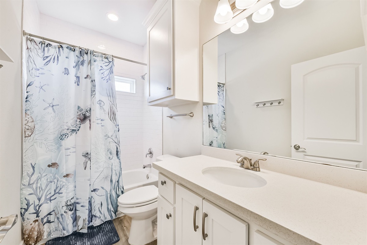 Shared full bathroom tub/shower combo.