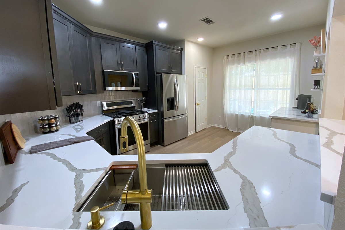 Cook in style in our modern kitchen, featuring sleek countertops, stainless steel appliances, & a spacious layout set for any culinary adventure. Whether you're brewing morning coffee or preparing a gourmet meal, this kitchen has everything you need!