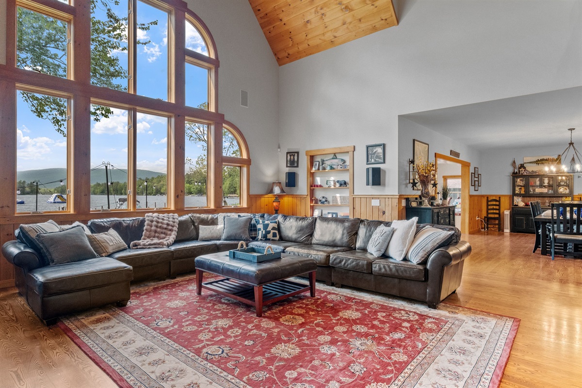 Living room with massive couch, 85" tv, sound system, pool table, and bubble hockey game