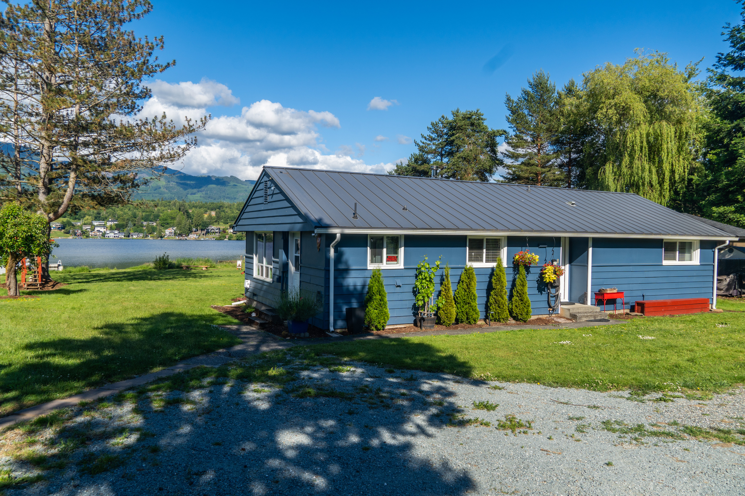 Tucked among the trees, this charming lake home offers a peaceful retreat just steps from the water. With ample parking, easy access, and a welcoming entrance, it's the perfect home base for your Big Lake getaway.