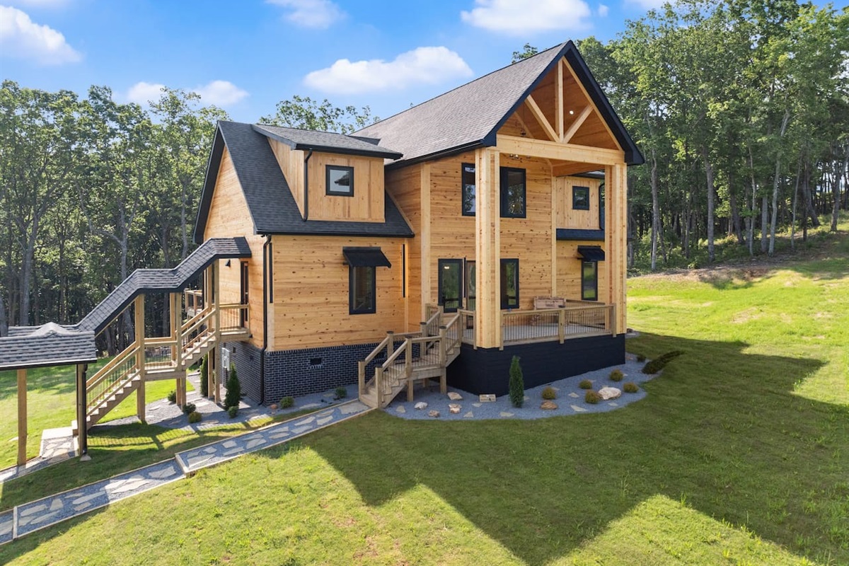 The elevated wraparound layout offers multiple stairways and easy access to nature all around.