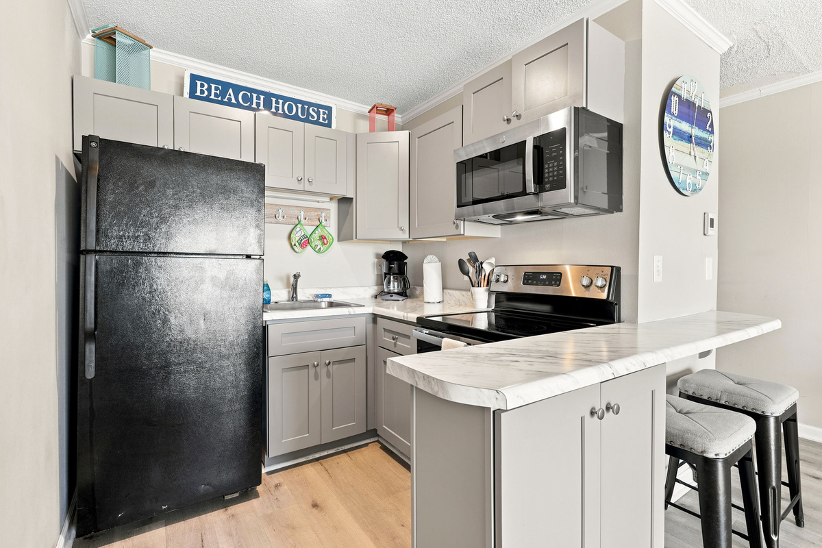 Prepare your favorite meals with ease in the fully stocked kitchen designed for convenient beachside living