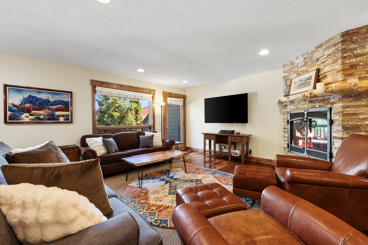 Spacious living room with seating for everyone in the group, gas fireplace, full sleeper sofa, and large TV