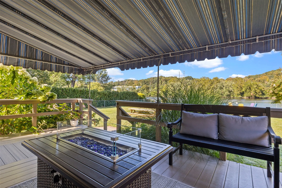 Cozy nights await! Gather around the fire table on the patio, perfectly set under the awning for year-round comfort