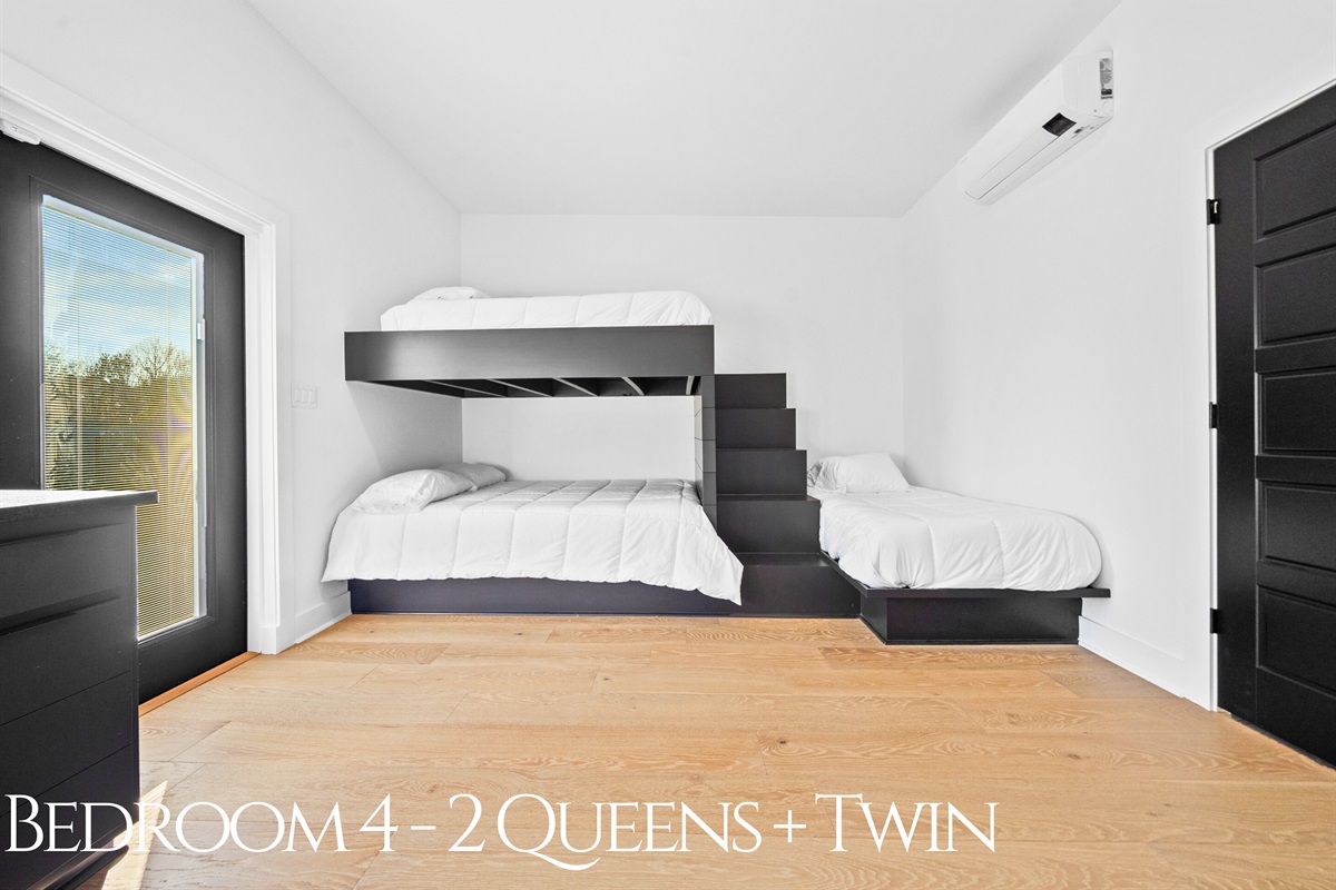A bright and airy bunk room with two queen beds and a twin, offering plenty of space and a clean, modern design for larger groups or families.