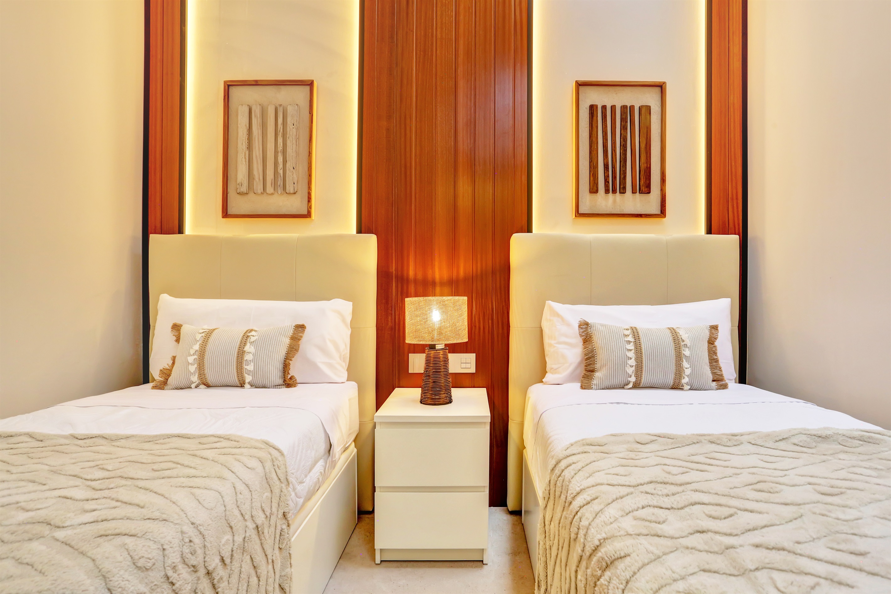 Elegant second bedroom with two single beds, thoughtfully designed to provide comfort and a restful night’s sleep.