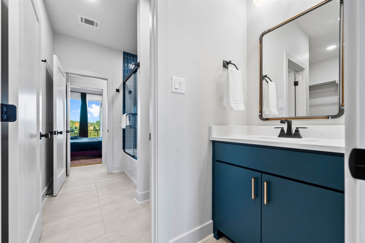A bright Jack n Jill style bathroom that leads to more comfort and style around every corner, making this home feel spacious and welcoming.