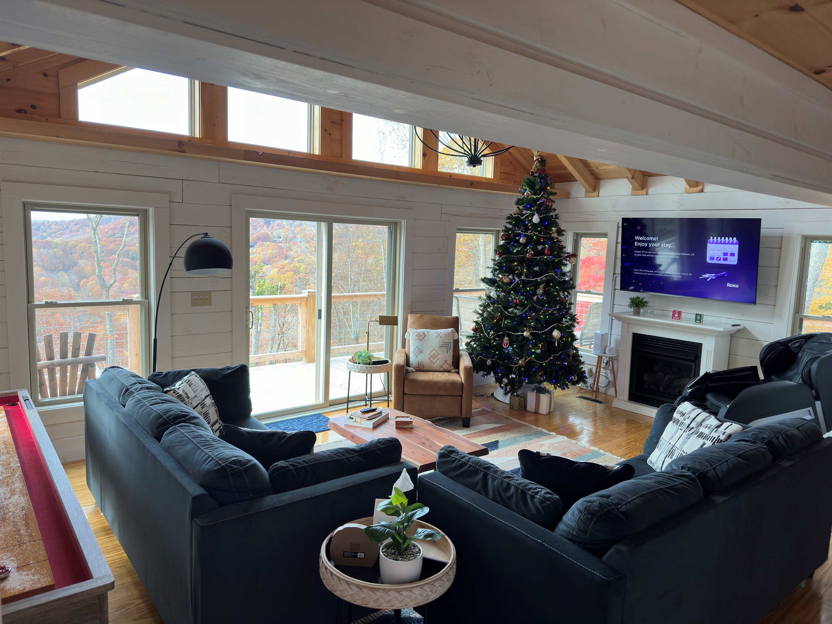 Bright family room with amazing mountain views, fireplace, Shuffleboard Table, and massage chair!  Two large couches that will seat your whole group!