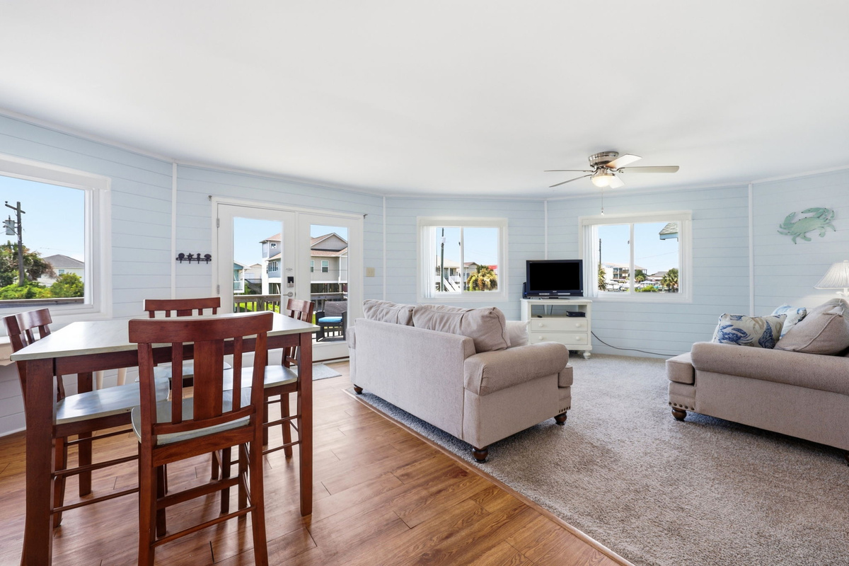 Open-concept living and dining area with easy deck access