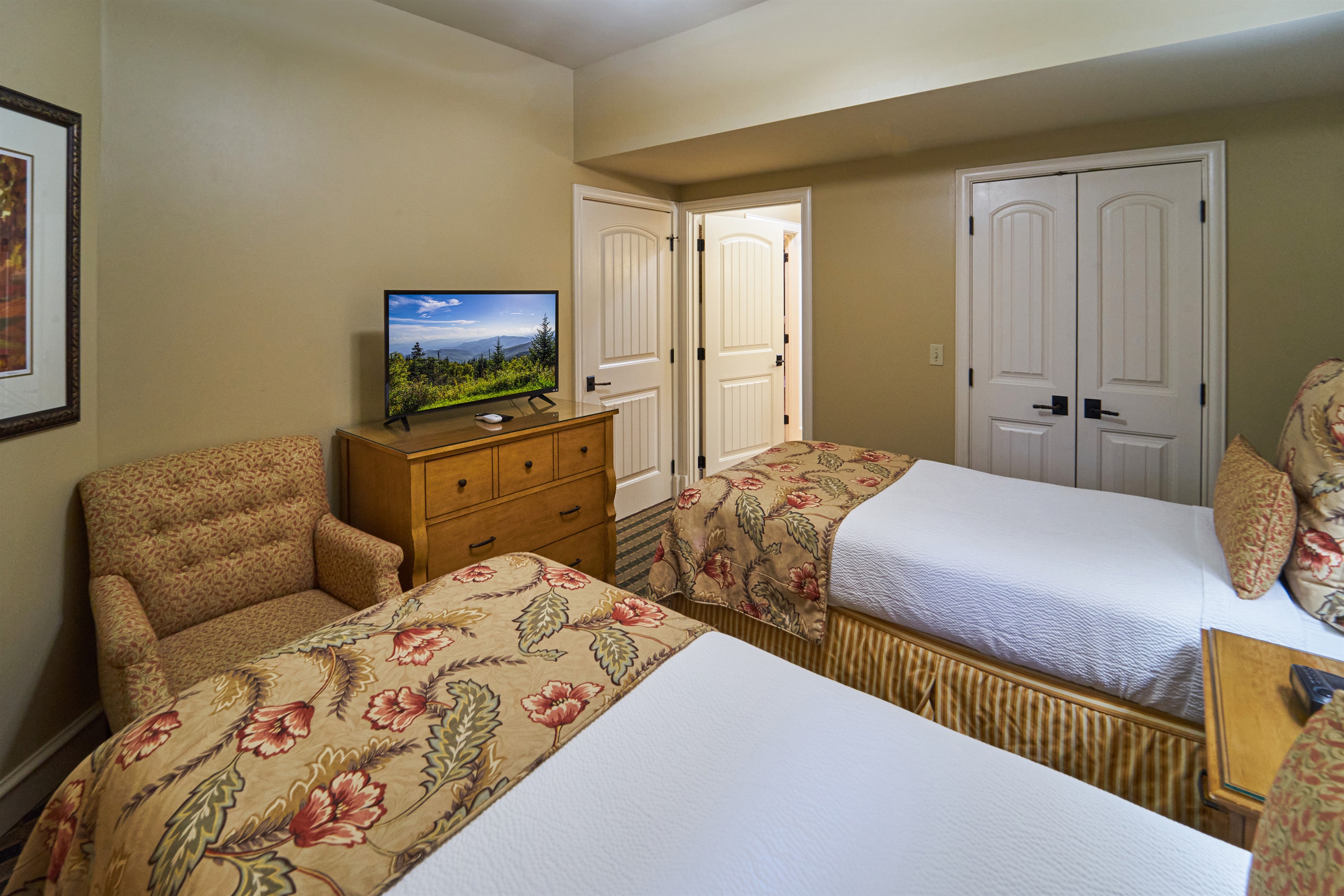 Twin Bedroom With Large Walk-In Closet and Flat Screen TV. This Room Has a Bathroom With Shower/Tub Combination. 