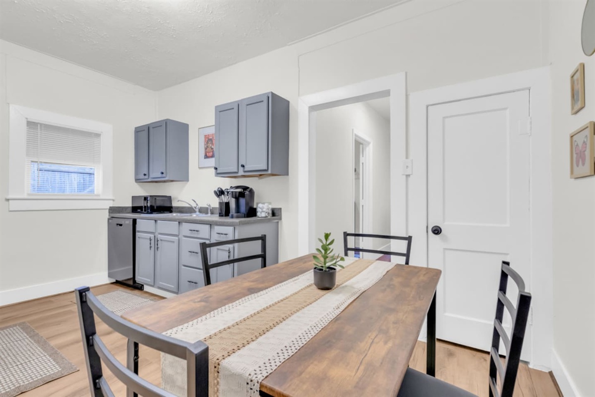 Open kitchen with island style seating and stainless steel appliances.