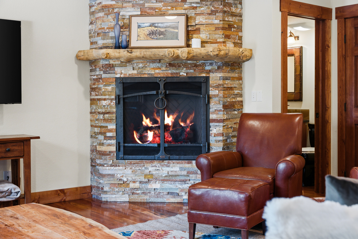 Living room detail. With a flip of a switch, the gas fireplace lights up to create extra heat and a warm ambience. 