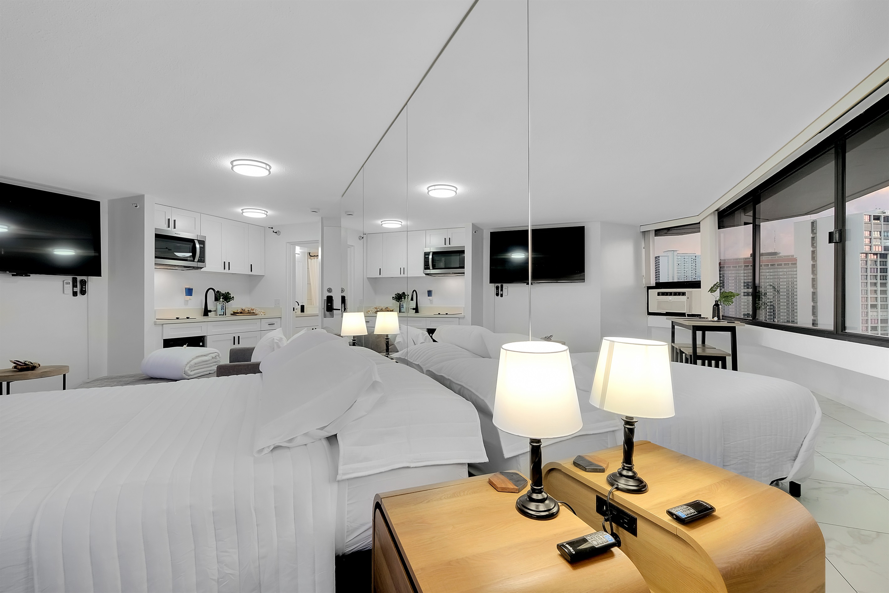 Elegant and serene — this bright Waikīkī studio combines luxury and comfort with crisp white linens, soft lighting, and mirrored walls that reflect panoramic marina views. Perfect for couples or solo travelers seeking a peaceful retreat near the beach.