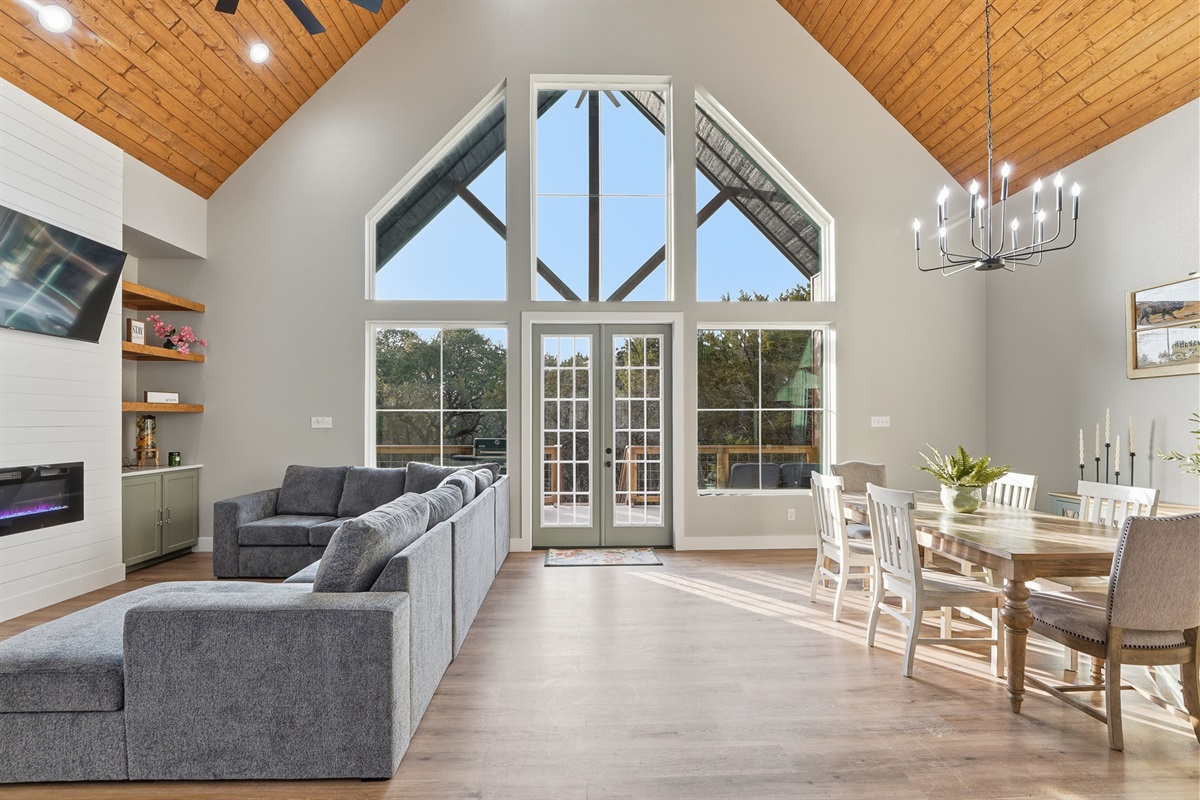 Vaulted ceilings, Oversized sectional seating, shiplap and a fire place create a gathering space at the heart of the home.