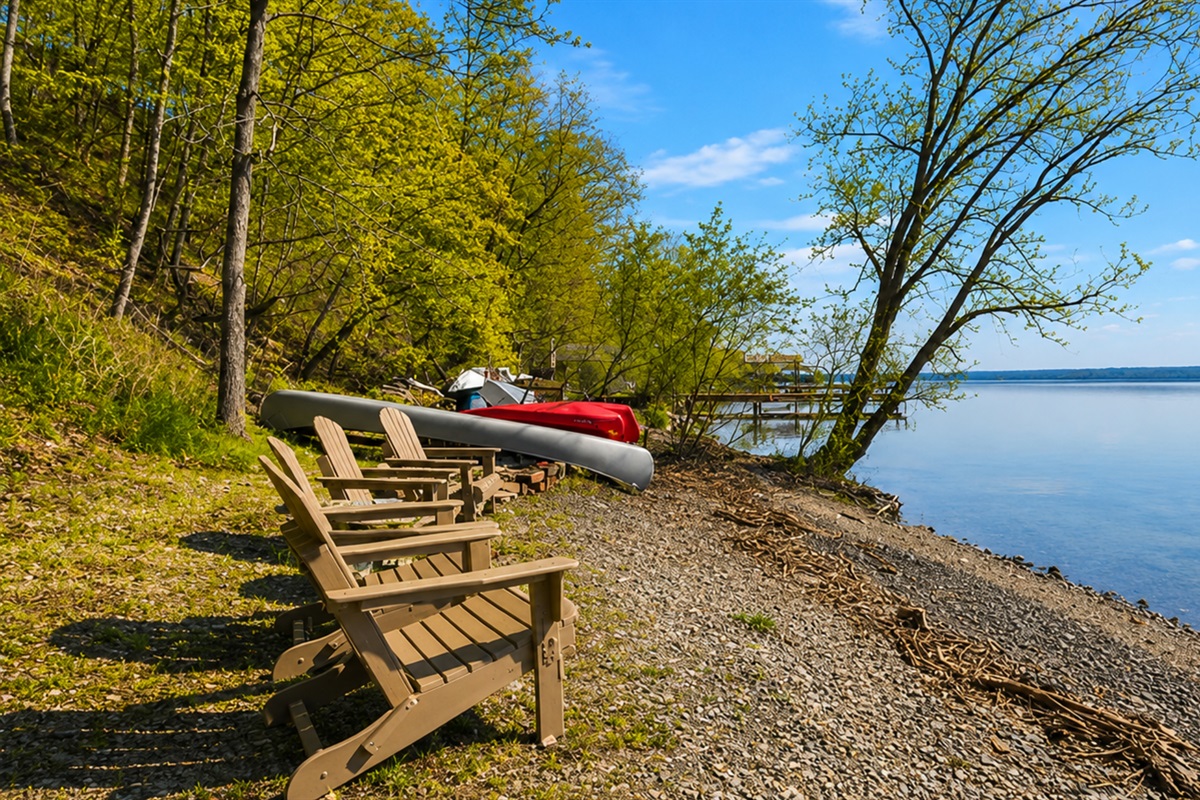 Lakefront / Boathouse / Dock (requires three flights of stairs to access)  -  Bask in the tranquility of our private lakeside beach, featuring comfortable loungers and direct water access, perfect for a serene day by the lake.