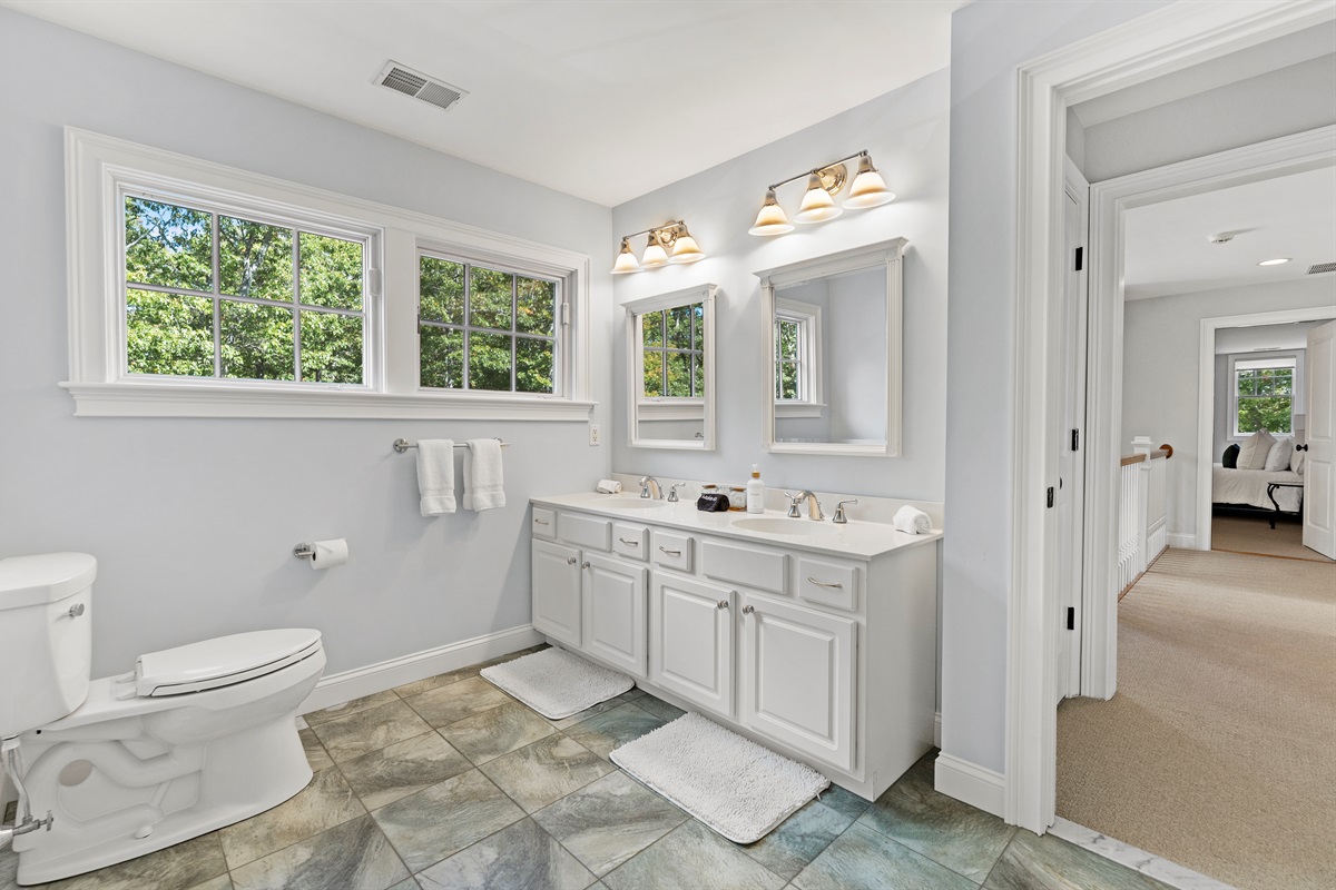 Upper-level shared bathroom with a full tub