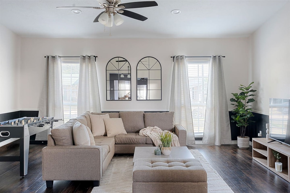 Relax on the comfortable couch next to the 65" HDTV or stand for a game of foosball