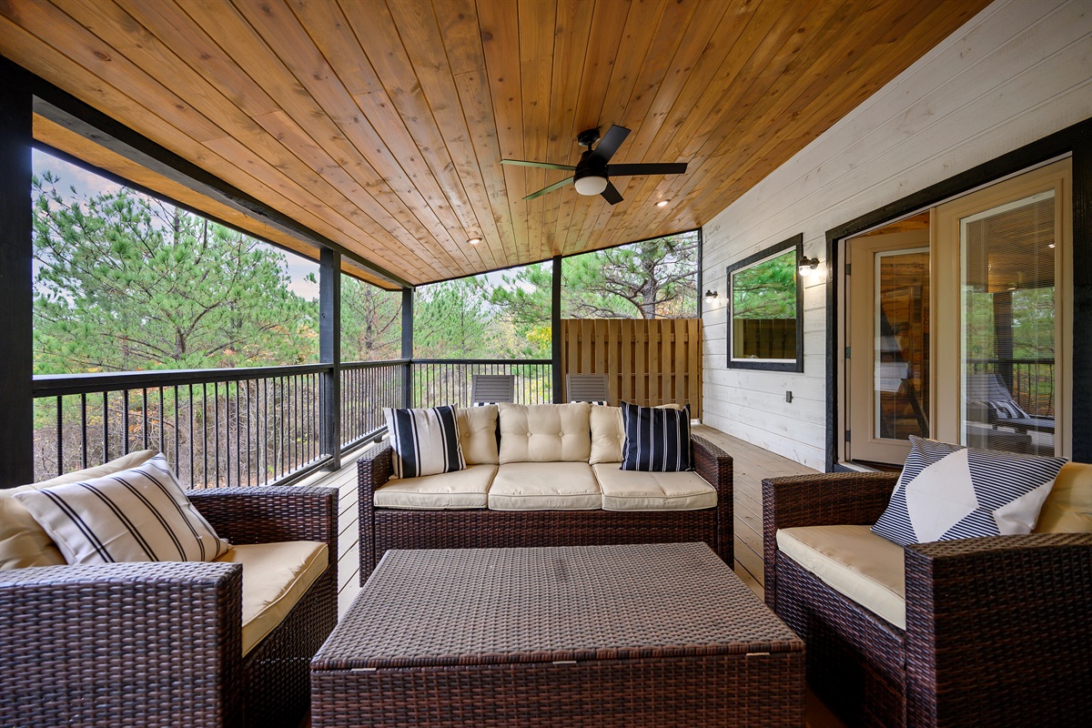 Upper level deck lounging with nothing but pine trees and peaceful vibes ahead. 
Slow mornings feel slower here, and somehow every conversation lasts a little longer under this covered retreat.