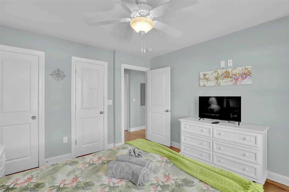 Another cozy guest room offering plenty of natural light and coastal charm.