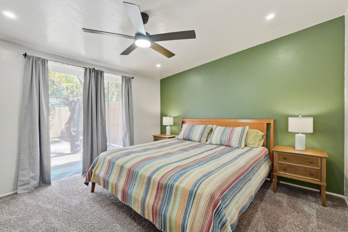 Sun-Drenched Serenity: Wake up to soft desert light and King-size comfort in this primary bedroom with ensuite.  *Note - the sliding glass doors do NOT open - serve as windows only.