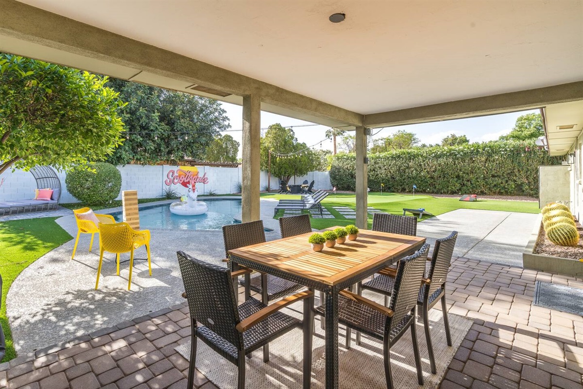 Large covered patio with dining table accompanies this resort-style back yard. Pool features a Baja step & can be heated for add'l fee. You'll also enjoy Giant Jenga, corn hole, putting green, & gas fire pit.