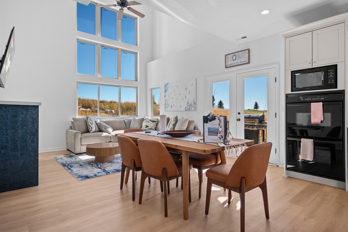 Enjoy the two story open-concept living area adjacent to the dining area and kitchen.  The upper level deck, complete with grill, is accessible via French doors.