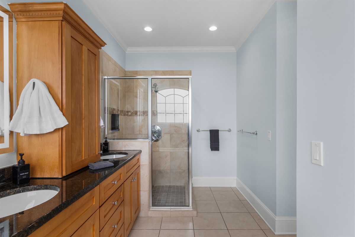 Walk in shower with jetted spray nozzles in the primary suite on the main level.