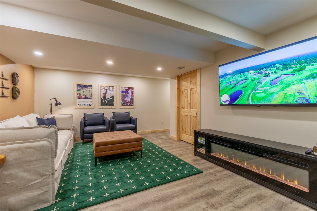 Basement living area with space to hang out, king bedroom, bathroom, electric fireplace, microwave, K-cup coffee maker and smart TV.