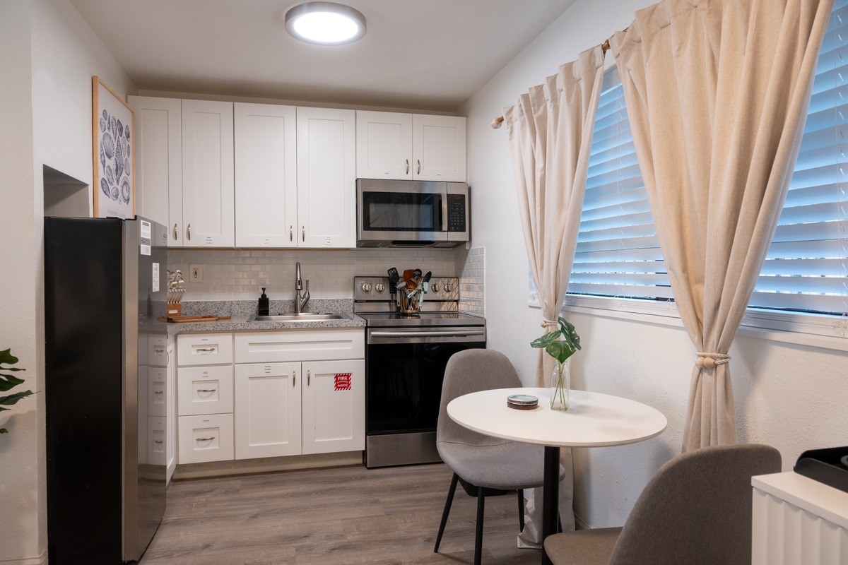 Fully equipped kitchen with stainless appliances and bistro dining table