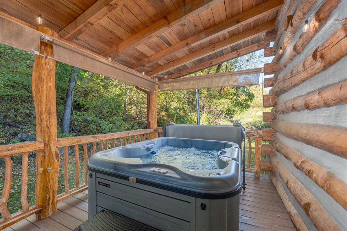 The hot tub is located on the back porch and offers privacy for guest to enjoy a relaxing soak. 