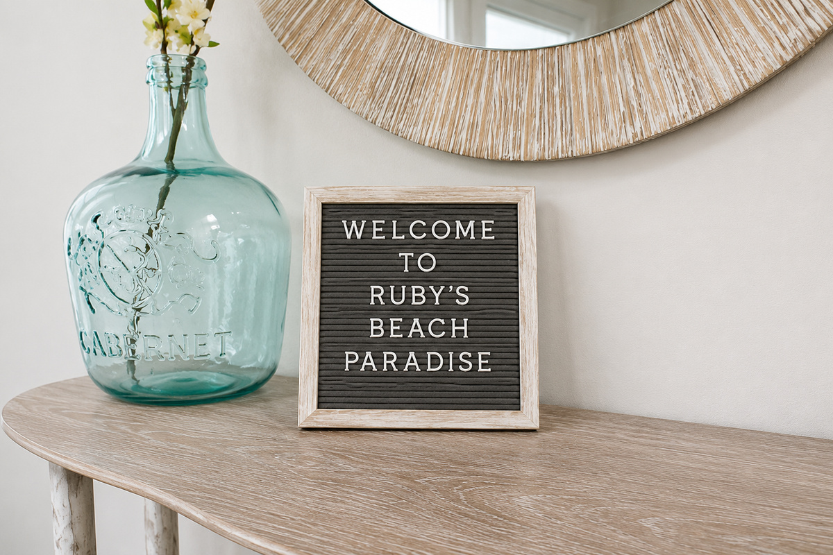 WELCOME TO RUBY'S BEACH PARADISE, spelled out letter by letter in the entry — it sets the tone for a stay where the pool is steps away, the beach is a short walk, and the family memories stack up fast.
