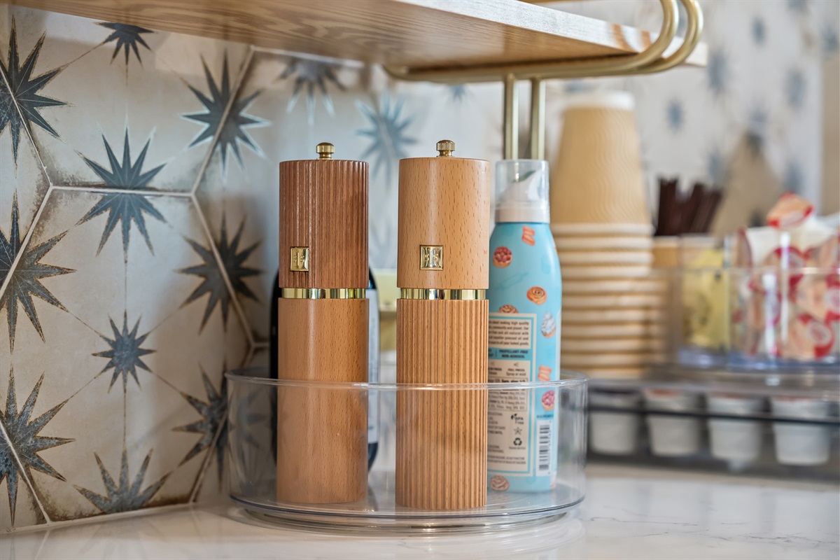 Kitchen stocked with spices and essentials.