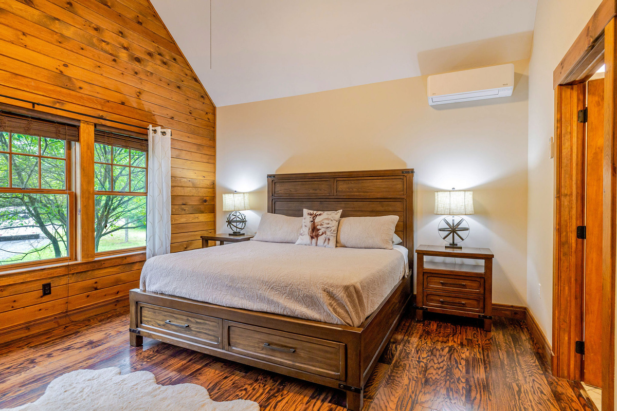 The king bedroom features vaulted ceilings, warm wood accents, and a peaceful retreat for restful nights.