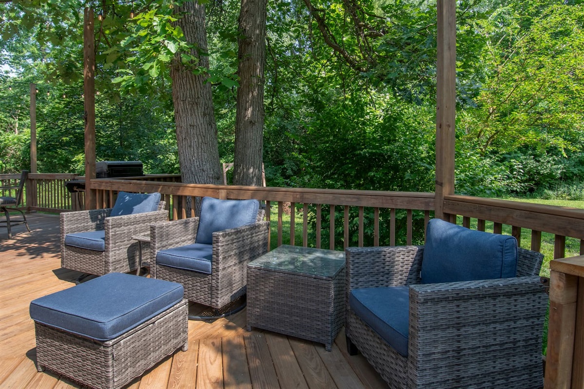 Deck is located by a variety of trees.