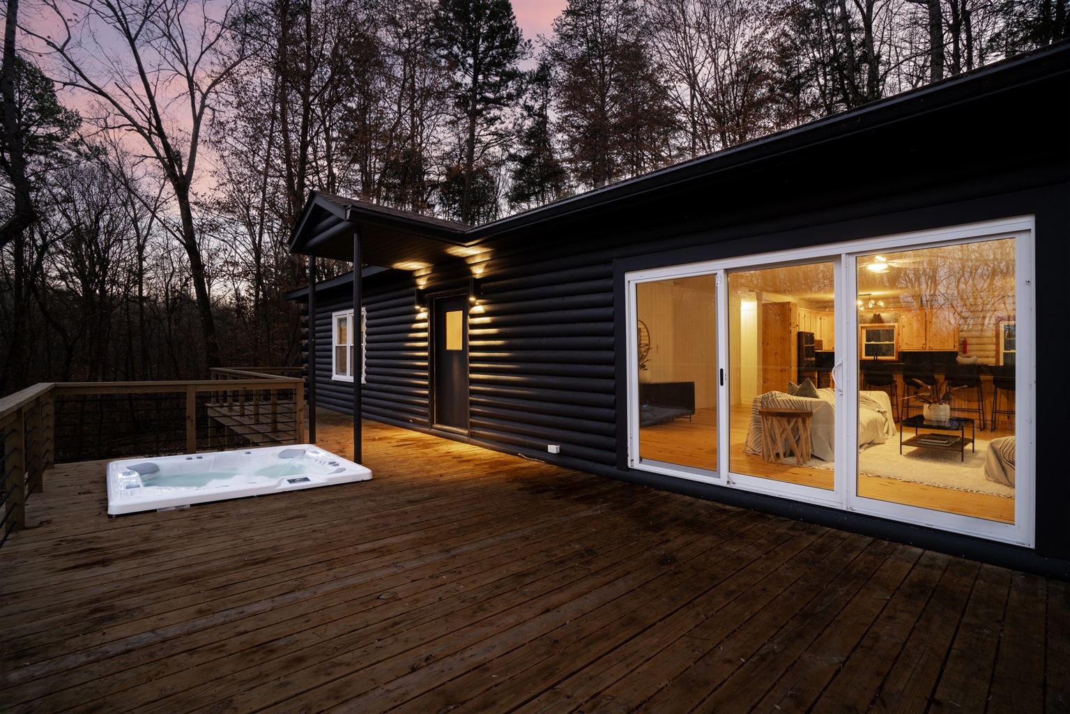 Outdoor Retreat: Relax in the hot tub while enjoying the serene wooded surroundings!