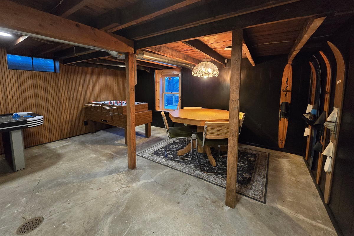 Gather 'round the table under this stunning chandelier!  Enjoy games, snacks, and cozy vibes in our basement—skis ready for your winter adventure! 