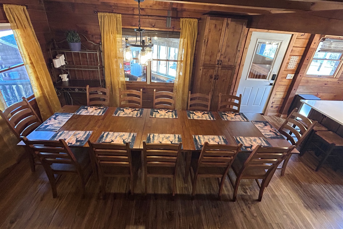 Everyone can eat meals together in the dining room. The bar stools at the kitchen island provide seats for those chatting with the cook. The door leads to the Sunroom.