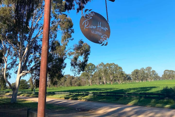 The entrance sets the tone for Bob’s River House, with gum trees, open paddocks and a quiet country road leading into the stay.