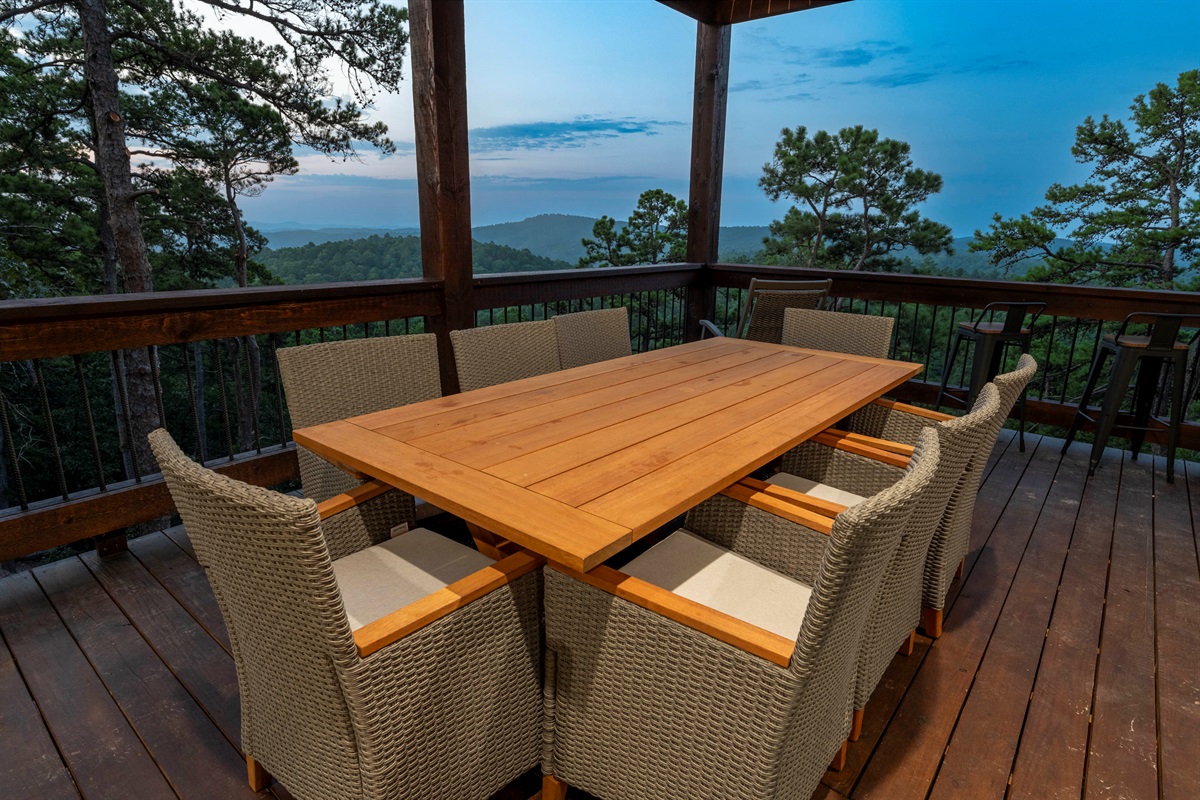 Cozy deck dining setup overlooking breathtaking mountain sunsets