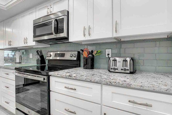 Gorgeous granite countertops and Glass tile backsplash
