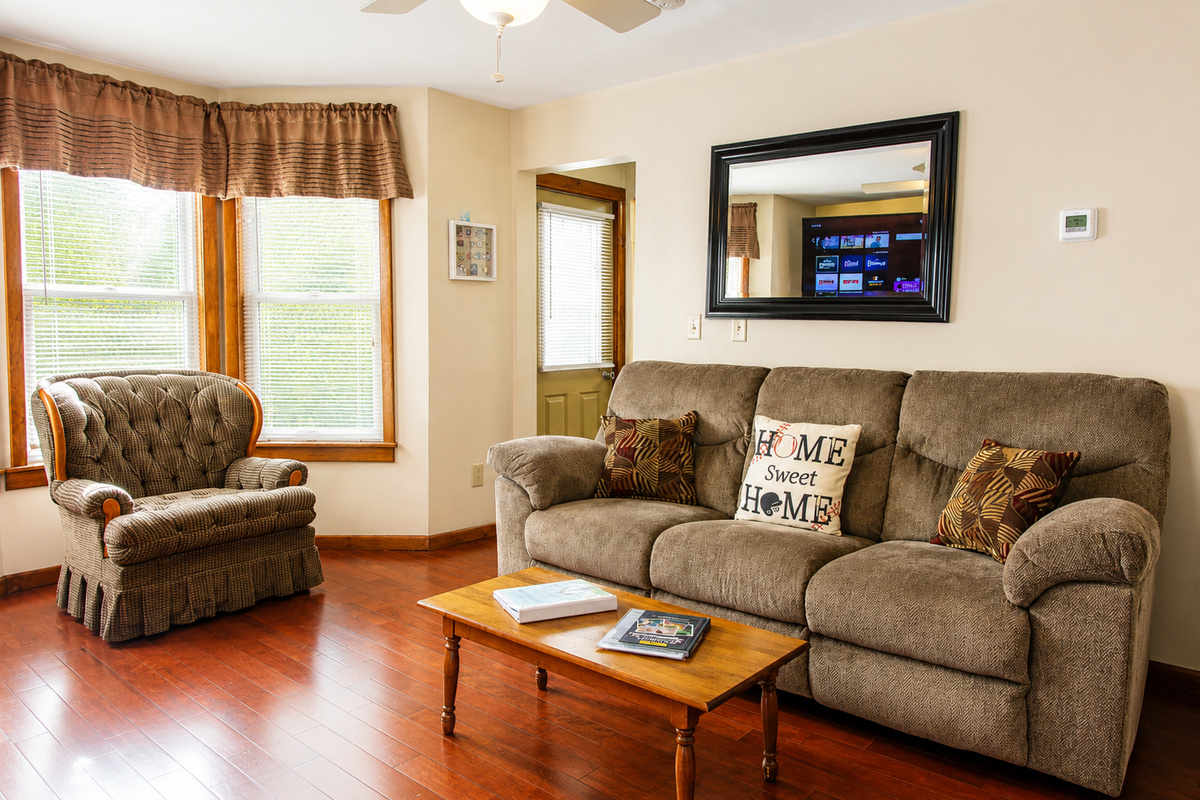 Living room with plenty of seating for everyone.  The comfy oversized chair is great to curl up with a book or a cup of coffee and your thoughts before you start your busy day!